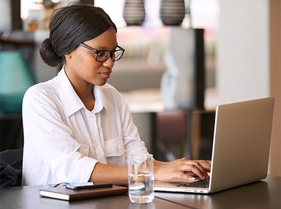 Professional on laptop device exploring C+D Data subscriptions.