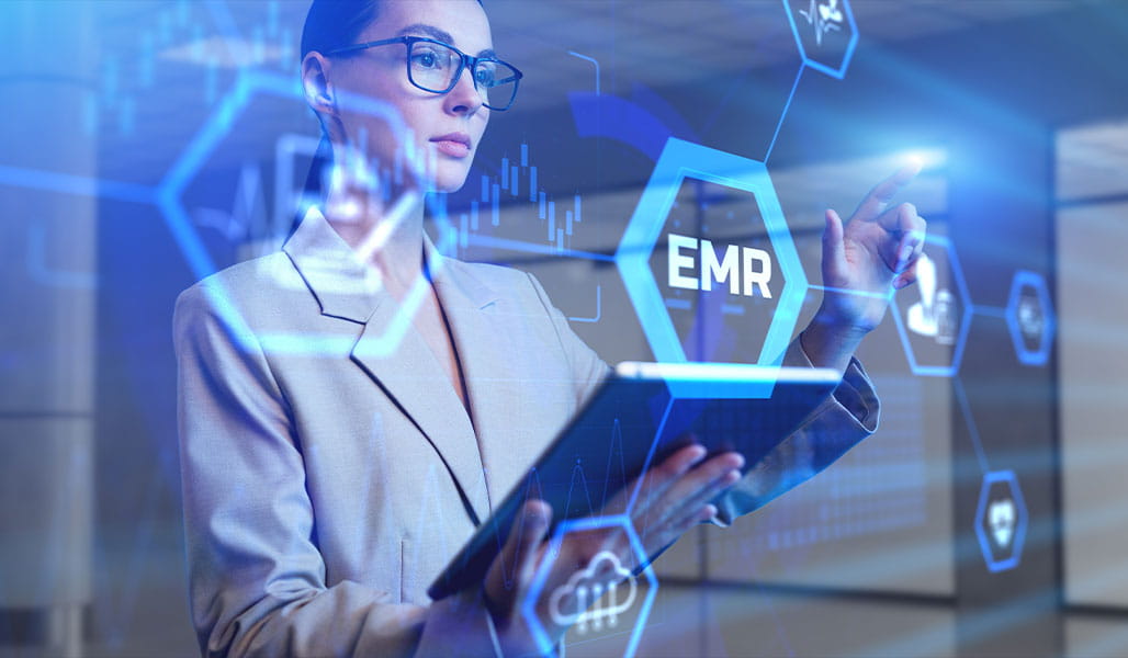 A professional interacts with holographic data related to electronic medical records.