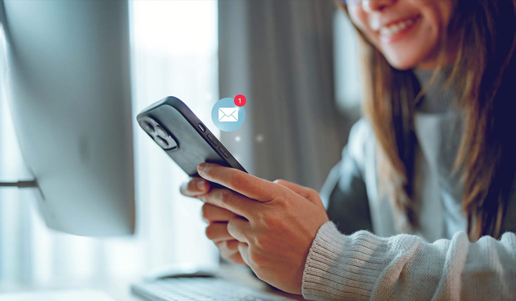 A woman checks her smartphone for alerts on upcoming clinical trial opportunities.