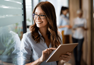 A person in an office holding a tablet.