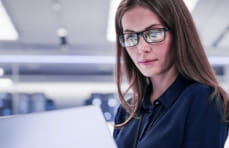 Pharmaceutical professional accessing C+D on a laptop device.