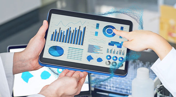 Group of researchers looking at tablet data in the lab