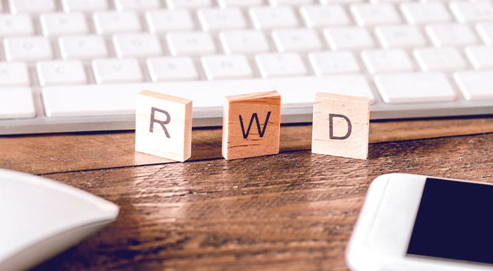 Three wood block tiles that spells out R W D.