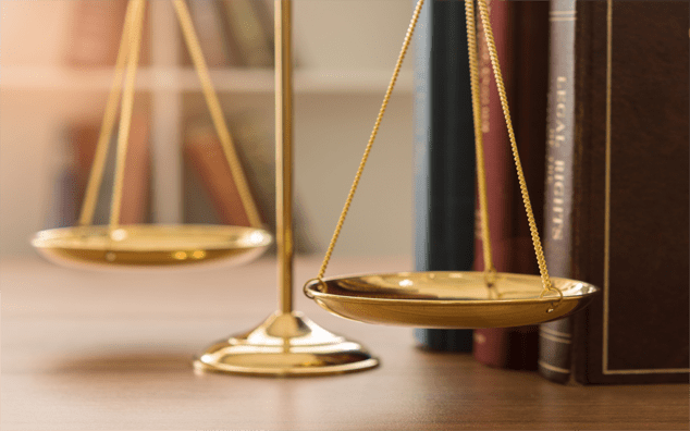 Scales of justice and legal book in courtroom