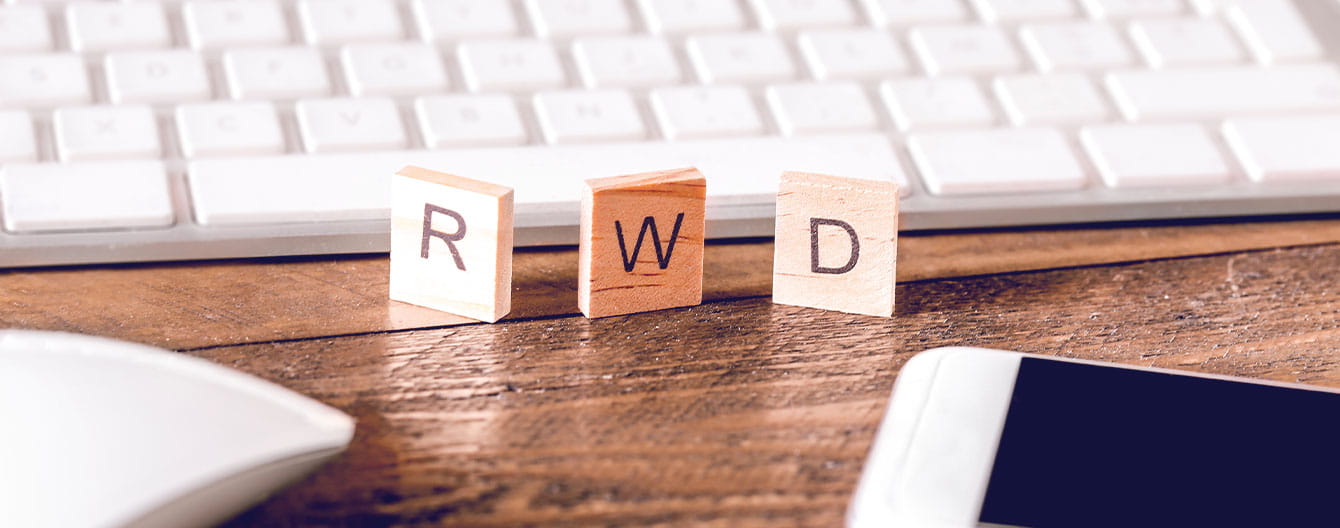 Three wood block tiles that spells out R W D.