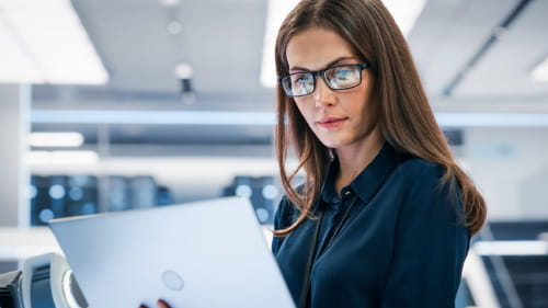 Woman looking at a laptop.
