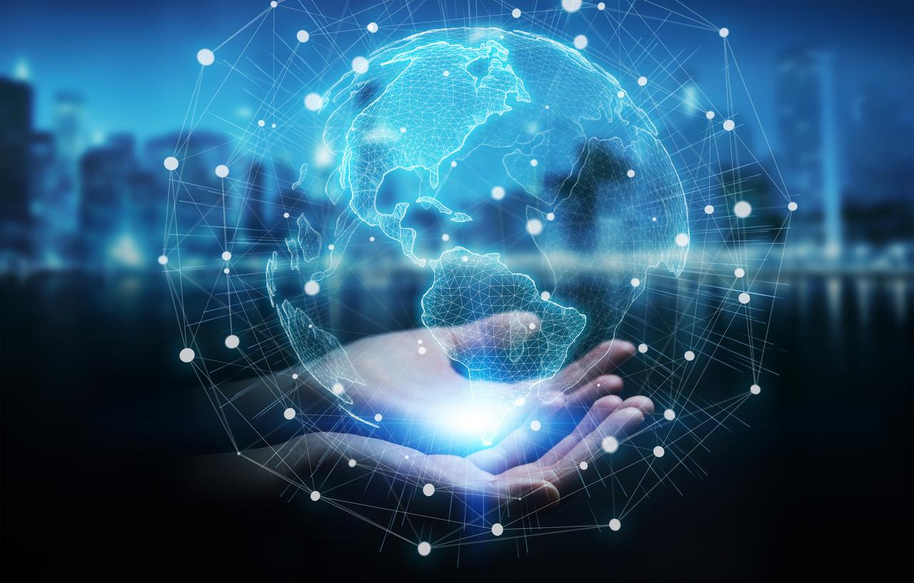 Hands with a digital projection of a globe.